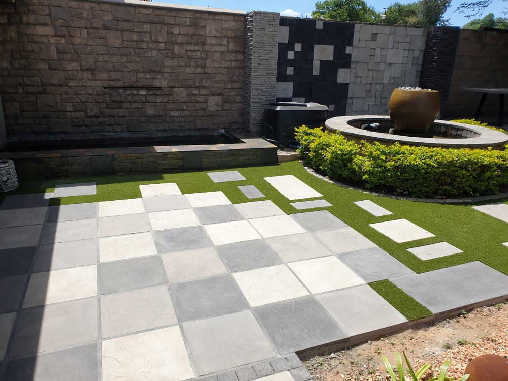 Estcourt Pavers in a mix of shades of grey, creating a beautiful garden landscape