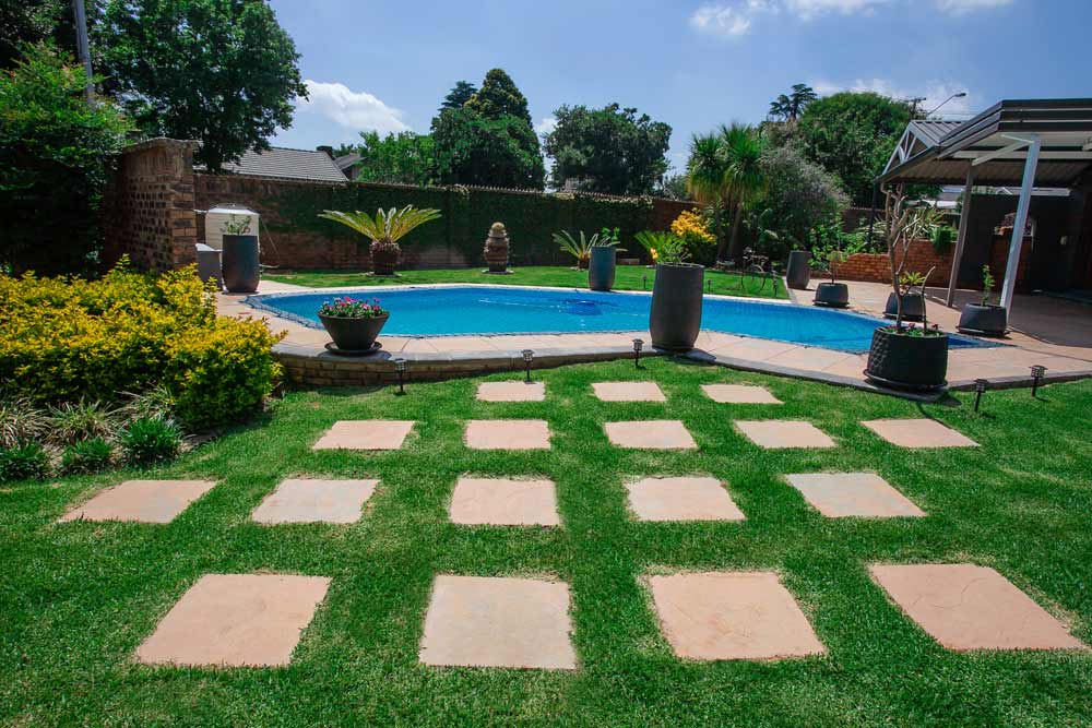 Estcourt Pavers used as Stepping Stones leading up to a pool surrounded by matching Estcourt Pavers