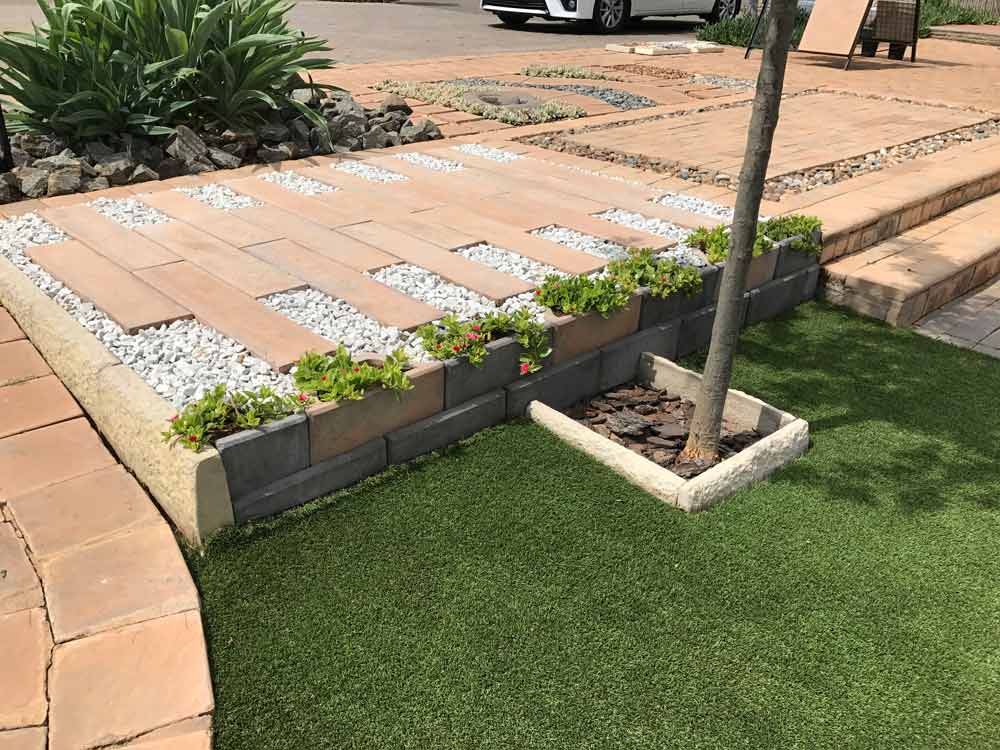 Mixed coloured Retaining Wall Blocks used to retain a garden wall along a walkway