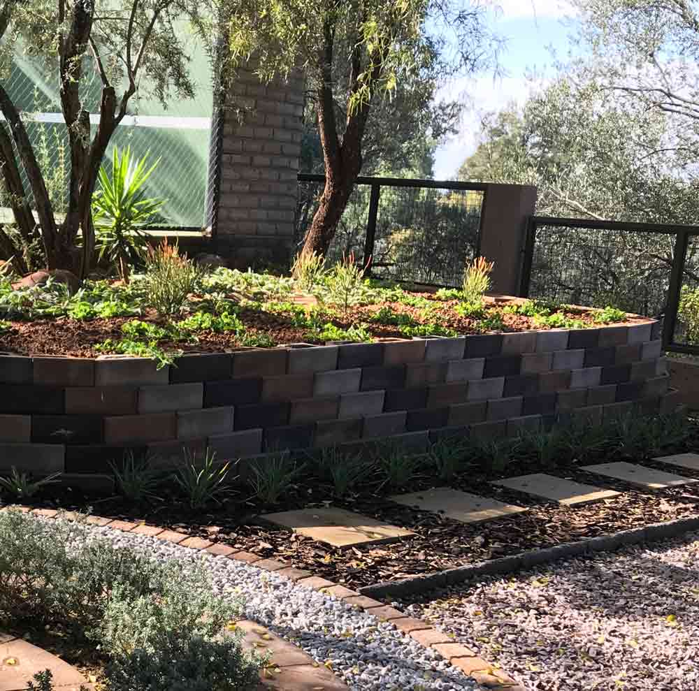 Retaining wall blocks creating levels and to edge off a flower bed