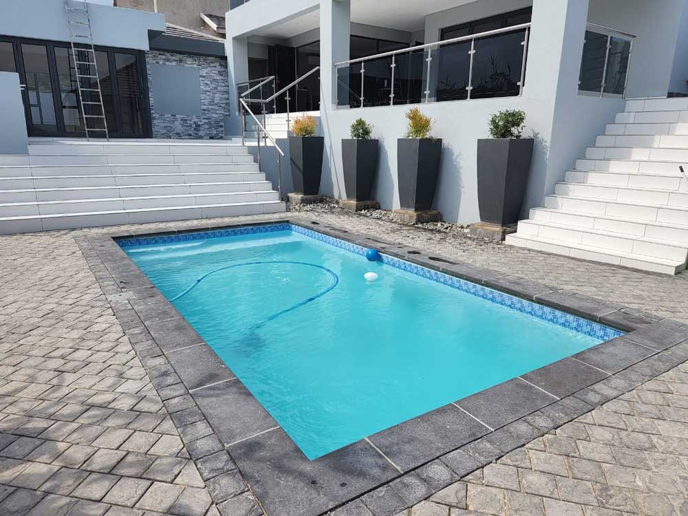 Charcoal newtown coping used around a pool in a modern home