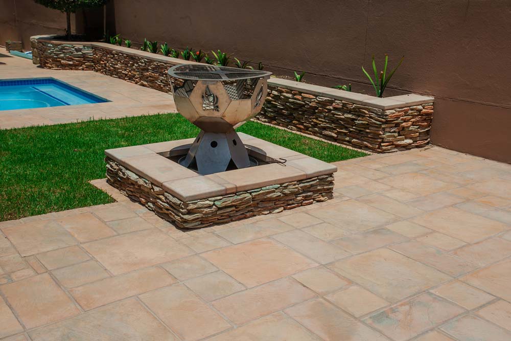 Newtown Coping in Sandstone used around a pool, firepit and garden landscaping